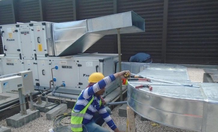 Technician at rooftop AHUs