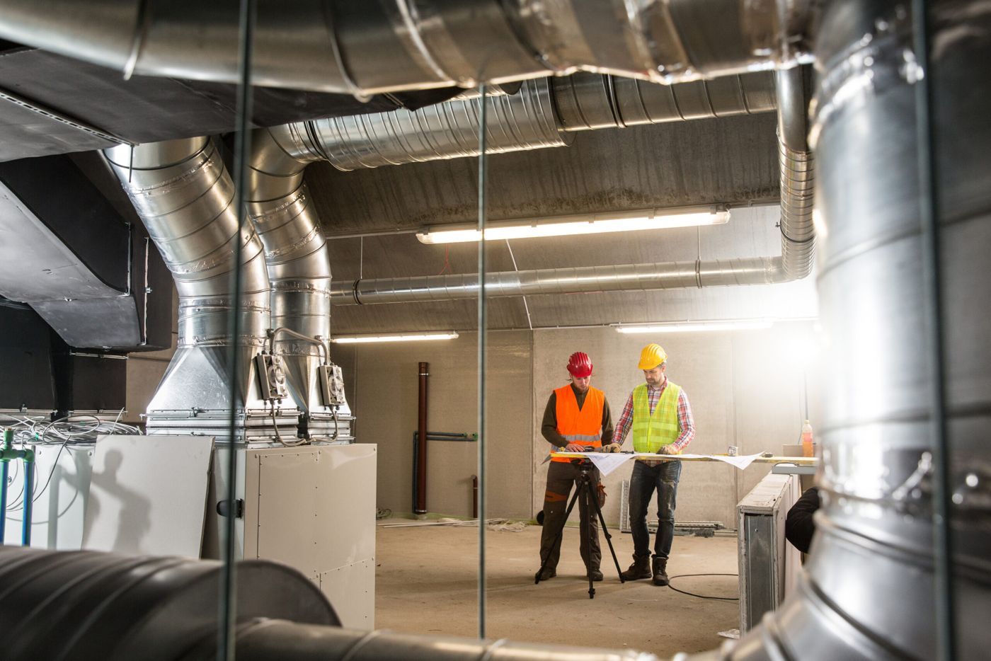 Engineers inspecting ductwork on site